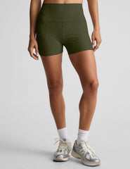 model is wearing green high-waisted 3" inseam shorts. 
