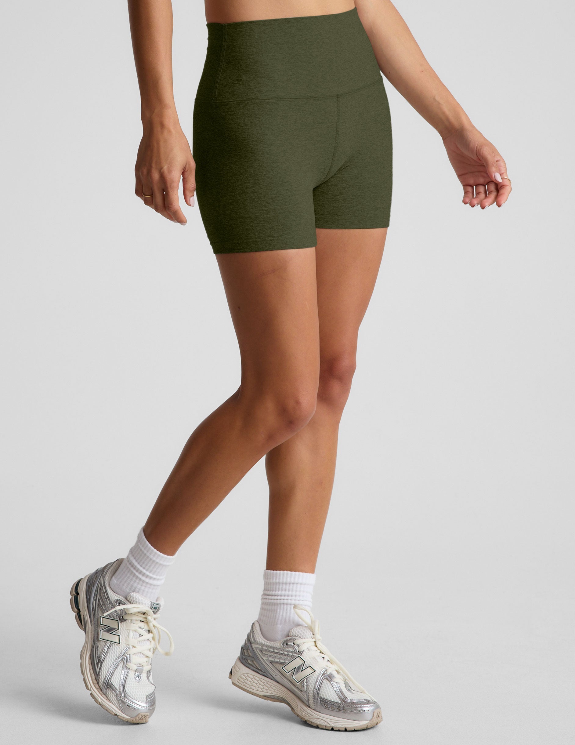 model is wearing green high-waisted 3" inseam shorts. 