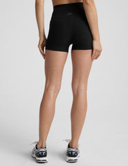 person wearing black 3" biker shorts on a plain background. 