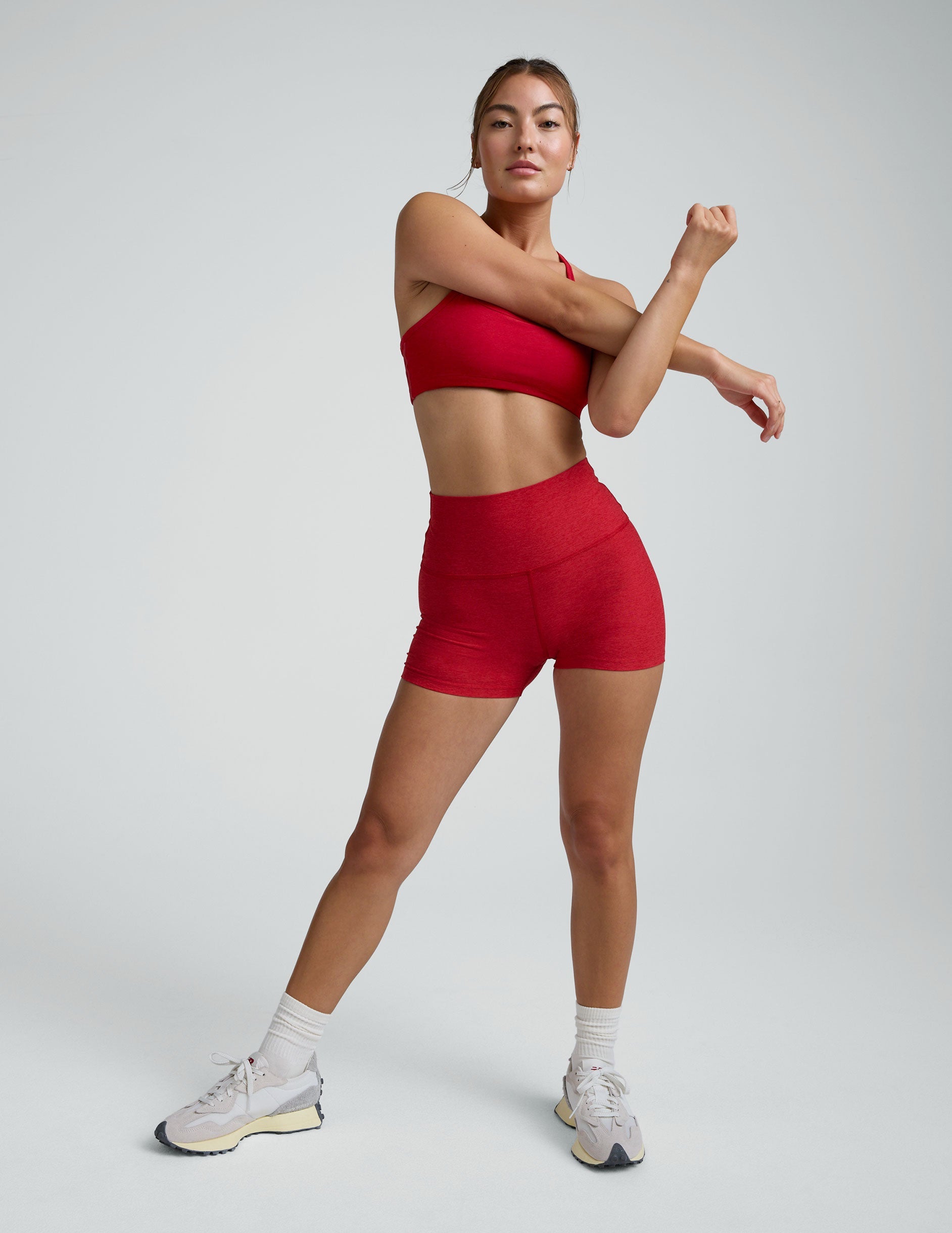woman wearing red 3" inseam biker shorts against a plain background. 