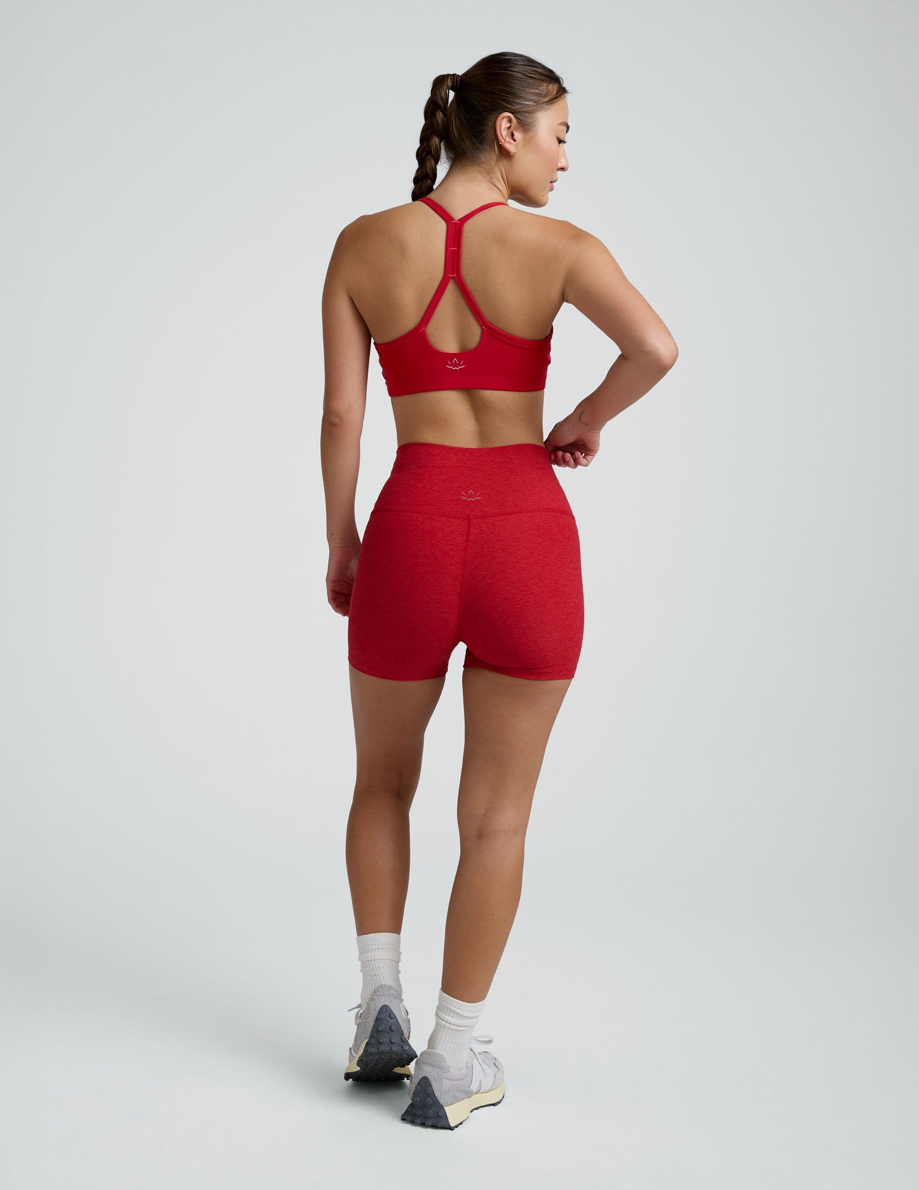 woman wearing red 3" inseam biker shorts against a plain background. 