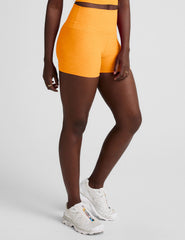 orange high-waisted 3" inseam biker shorts. 