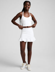 white skirt with a ruffle hem and built-in shorts with pockets.