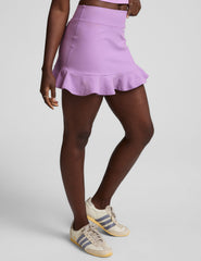 purple high-waisted skirt with a ruffle hem and built-in shorts with pockets.