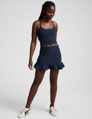 blue high-waisted skirt with a ruffle hem and built-in shorts with pockets.