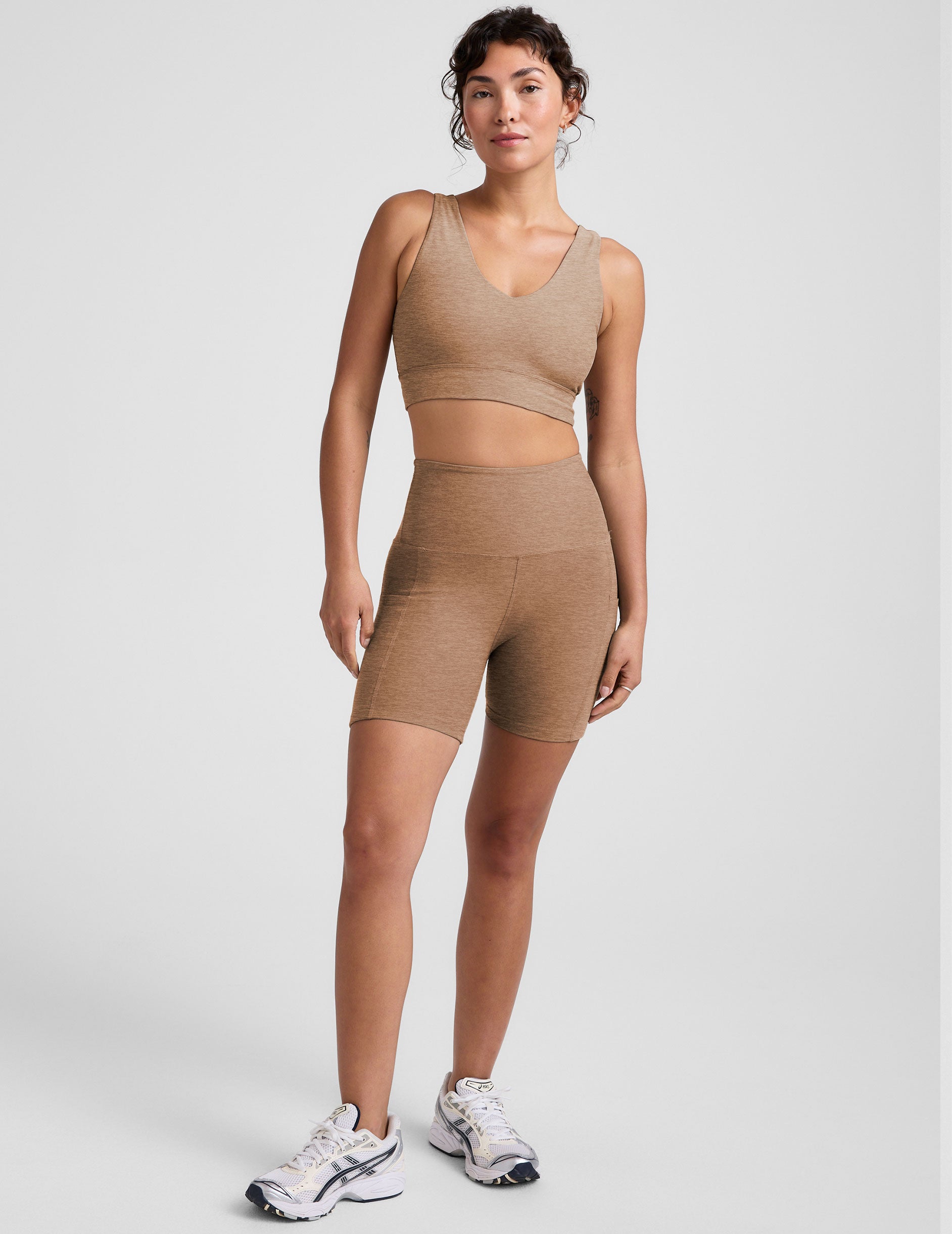 tan high-waisted 5" inseam biker shorts with pockets. 