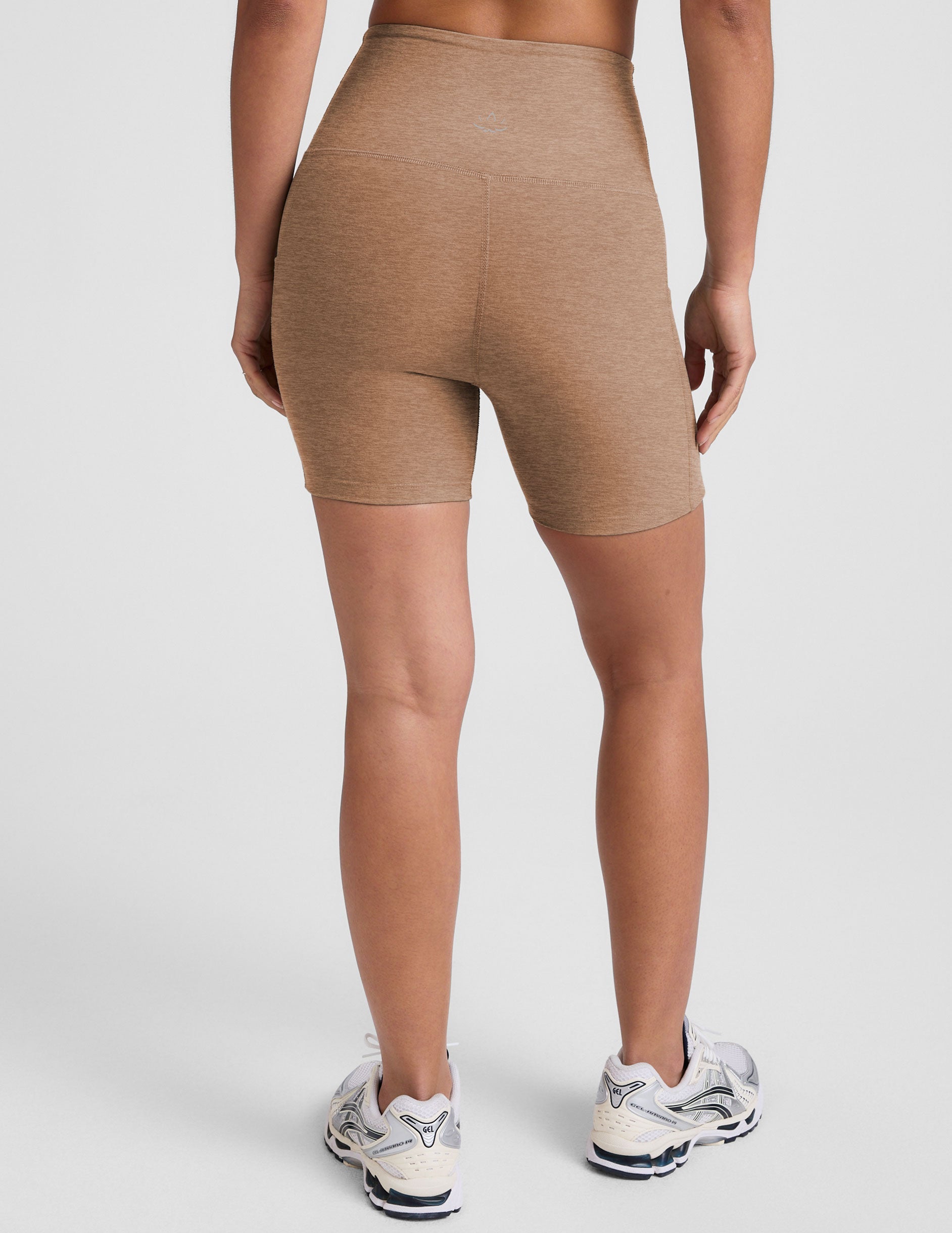 tan high-waisted 5" inseam biker shorts with pockets. 