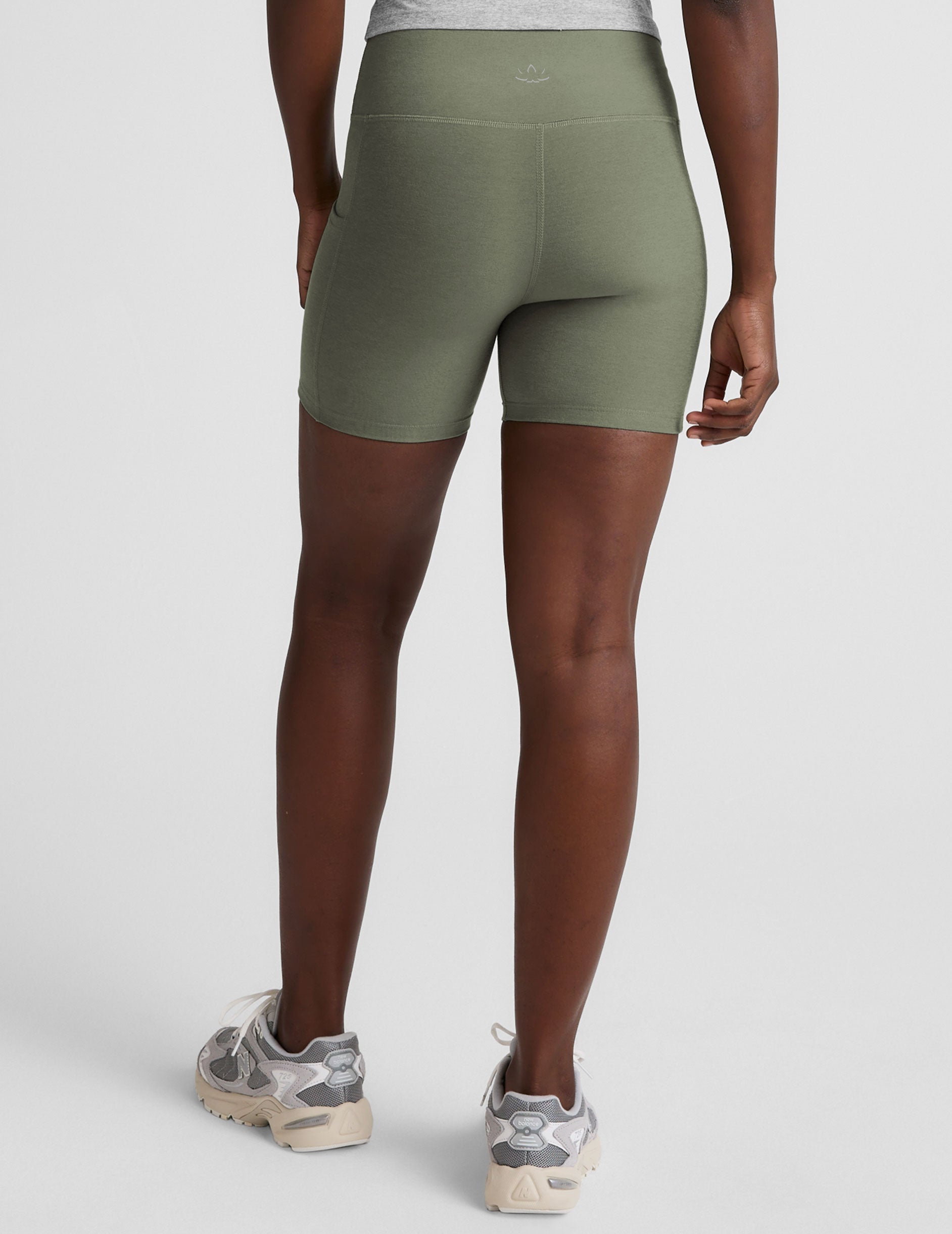 green high-waisted 5" inseam biker shorts  with pockets. 