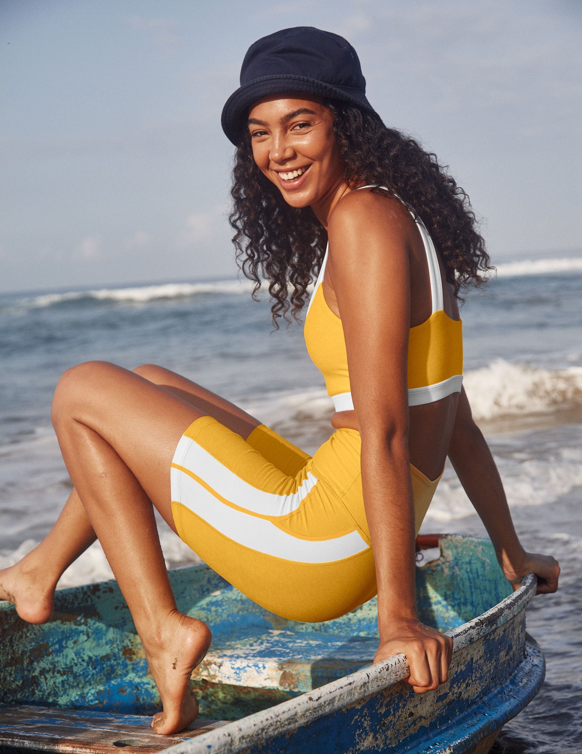 yellow high-waisted spacedye biker shorts with white lining down the sides.