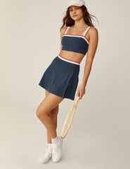 blue spacedye wrap mini skirt with white and red outline along the waistband and a front slit.