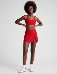 red mini skirt with built-in shorts and a front side slit.
