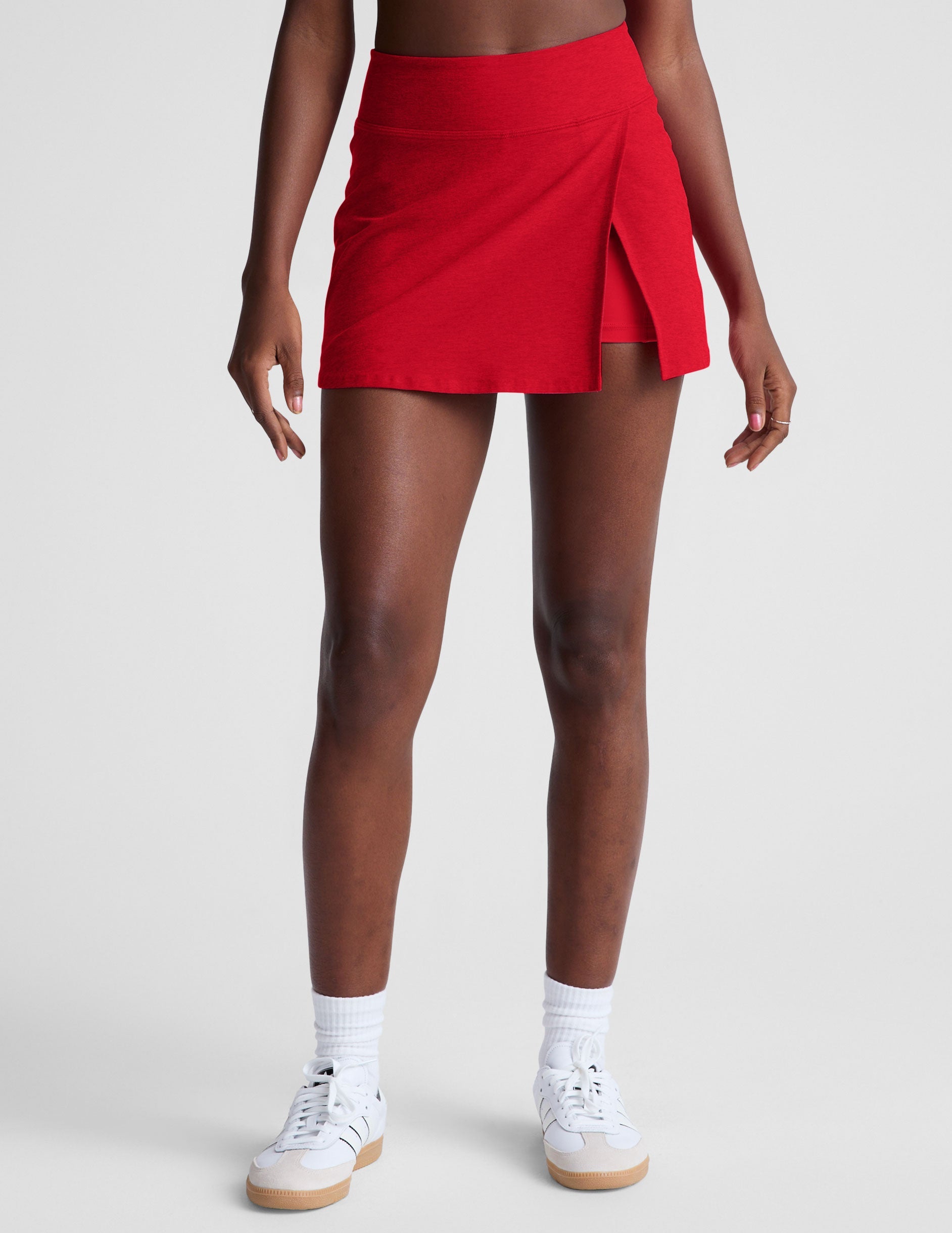 red mini skirt with built-in shorts and a front side slit.