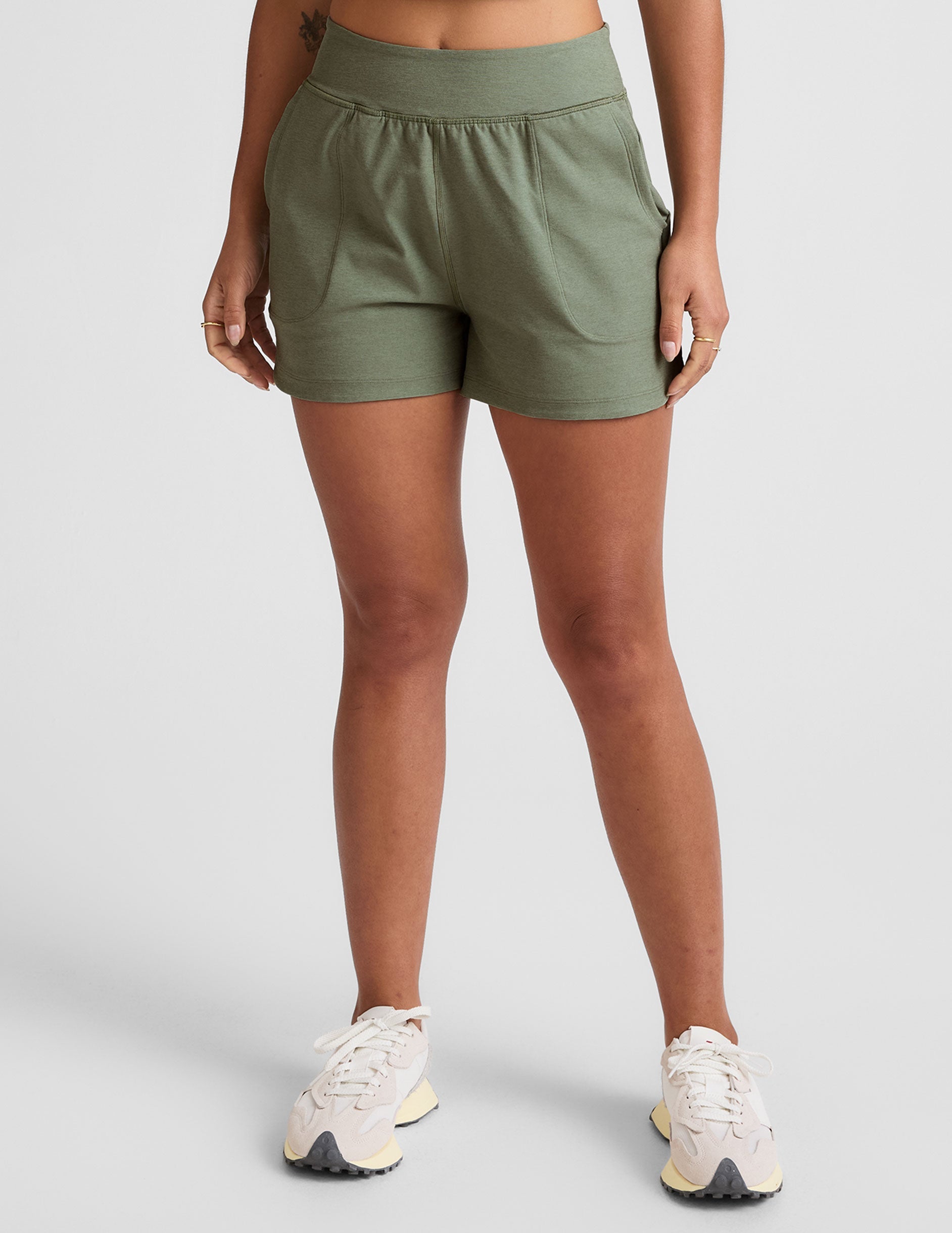 green mid-rise 3" inseam shorts with pockets. 