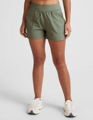 green mid-rise 3" inseam shorts with pockets. 