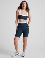 navy blue high-waisted biker shorts with a 5" inseam, waistband colorblock panels​, and contrast piping detail on leg​. 