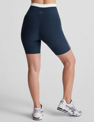 navy blue high-waisted biker shorts with a 5" inseam, waistband colorblock panels​, and contrast piping detail on leg​. 