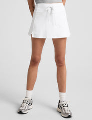white mini skirt with a drawstring at waistband and built in shorts with pockets.
