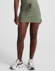 green mini skirt with a drawstring at waistband and pockets.