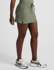 green mini skirt with a drawstring at waistband and pockets.