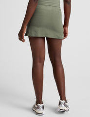 green mini skirt with a drawstring at waistband and pockets.