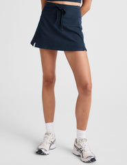 blue mini active skirt with a drawstring at waistband and built in shorts with pockets.