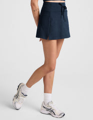 blue mini active skirt with a drawstring at waistband and built in shorts with pockets.