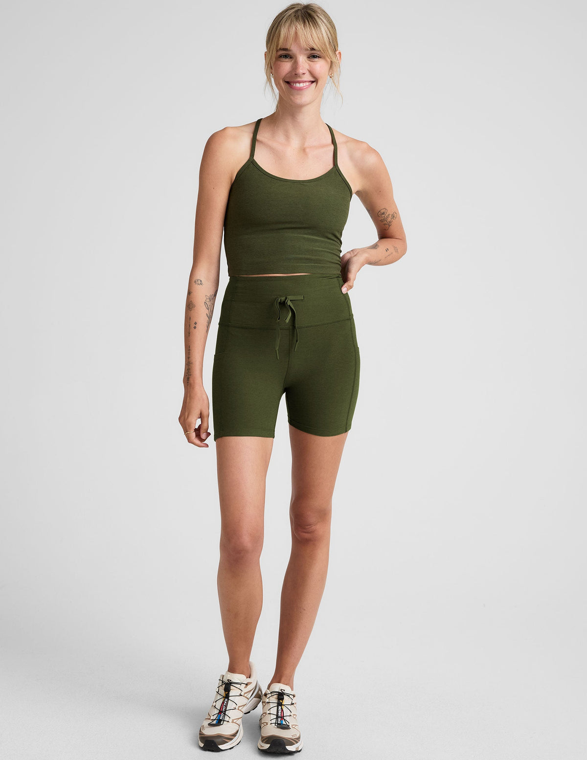 green 5" inseam biker shorts with pockets and a drawcord at waistband. 