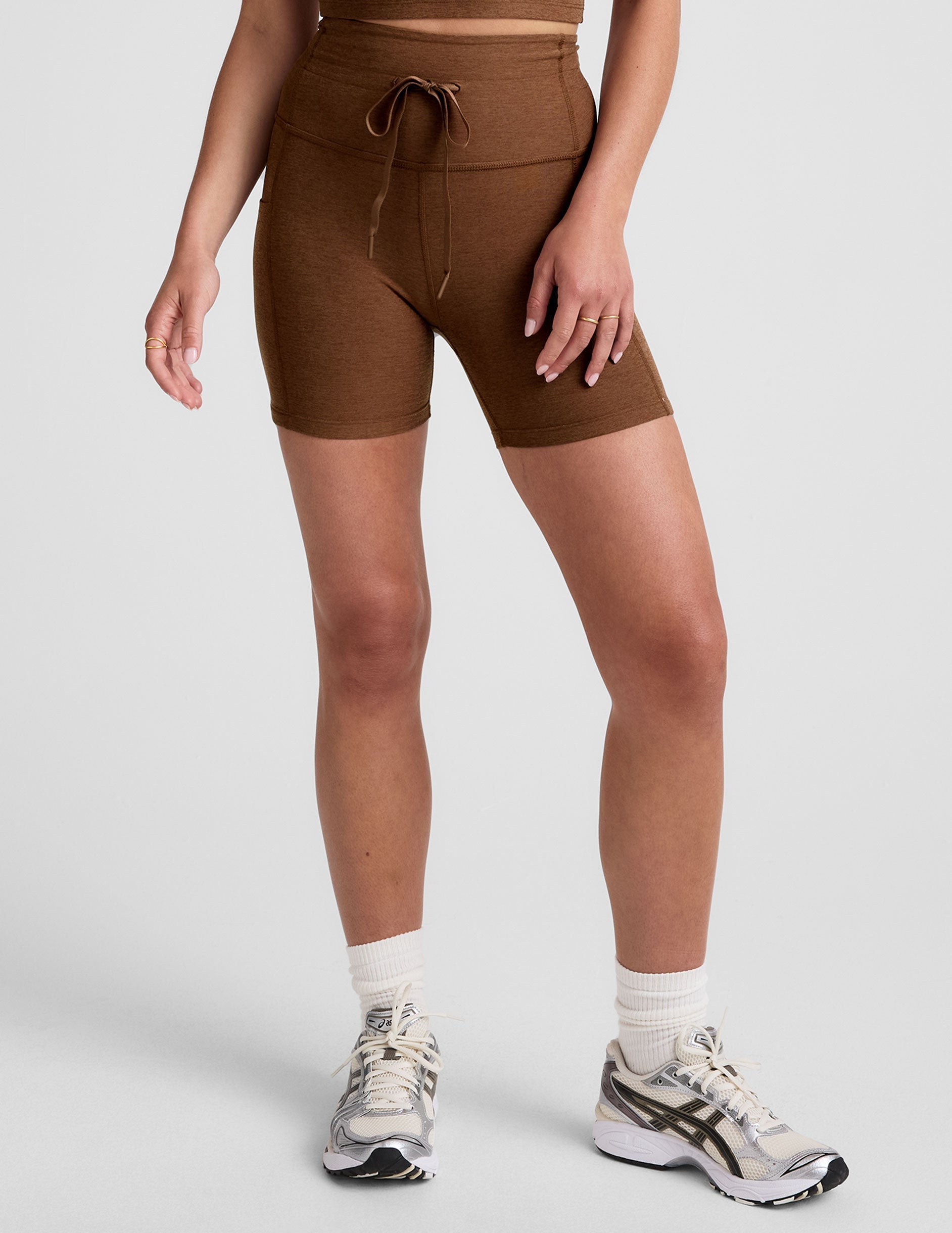 brown high-waisted 5" inseam biker shorts with a drawstring at waistband and side pockets. 