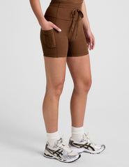 brown high-waisted 5" inseam biker shorts with a drawstring at waistband and side pockets. 