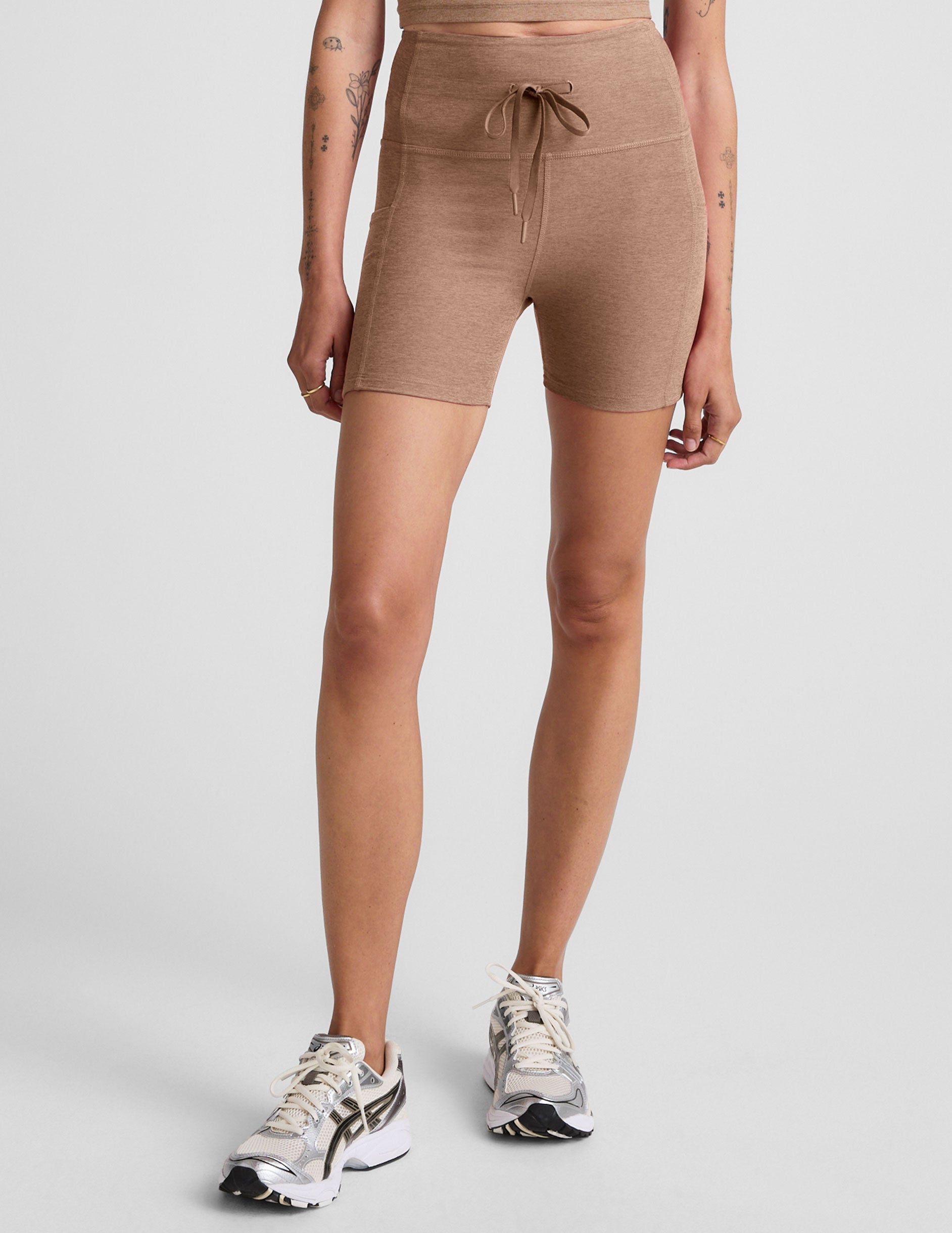 brown high-waisted 5" inseam biker shorts with pockets and a drawstring at waistband. 
