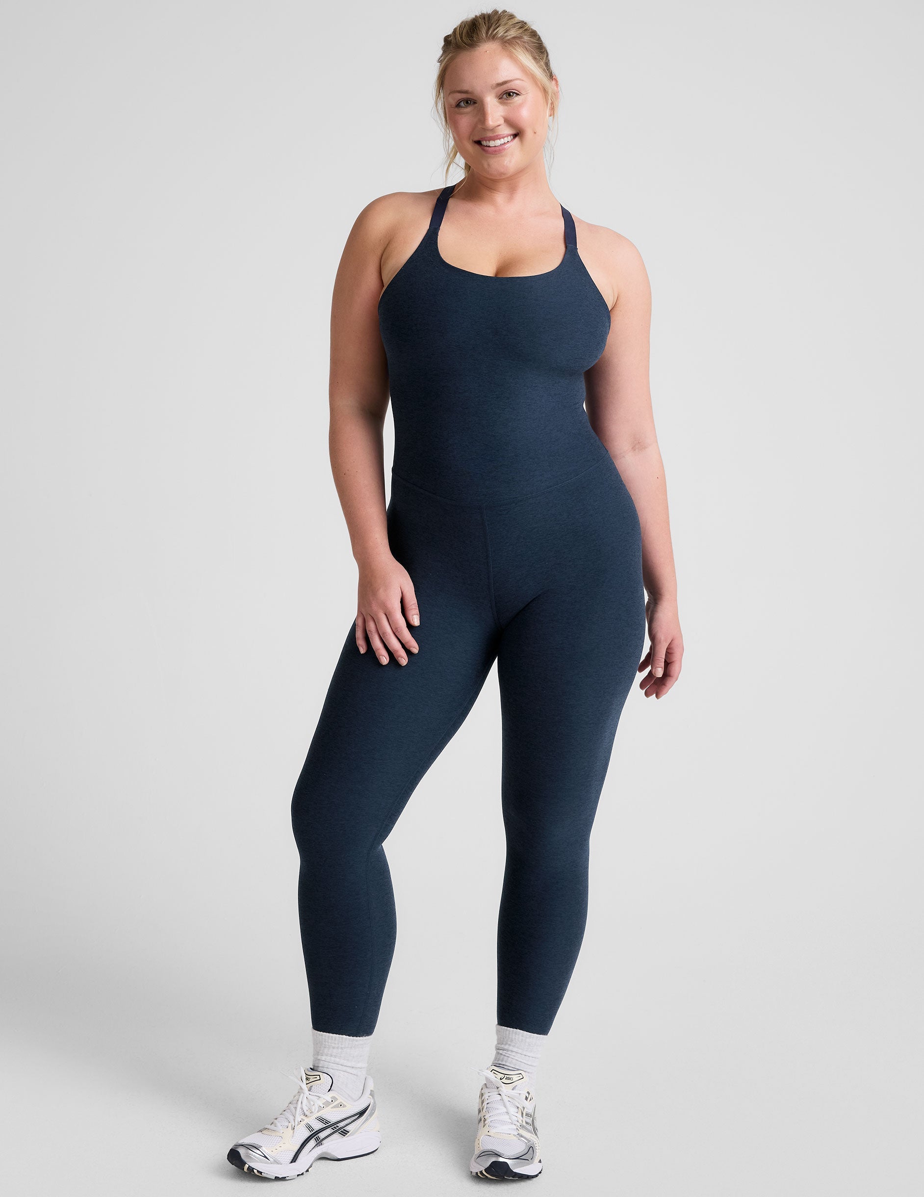 blue midi length jumpsuit with cross straps on back.