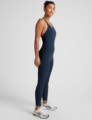 blue midi length jumpsuit with cross straps on back.