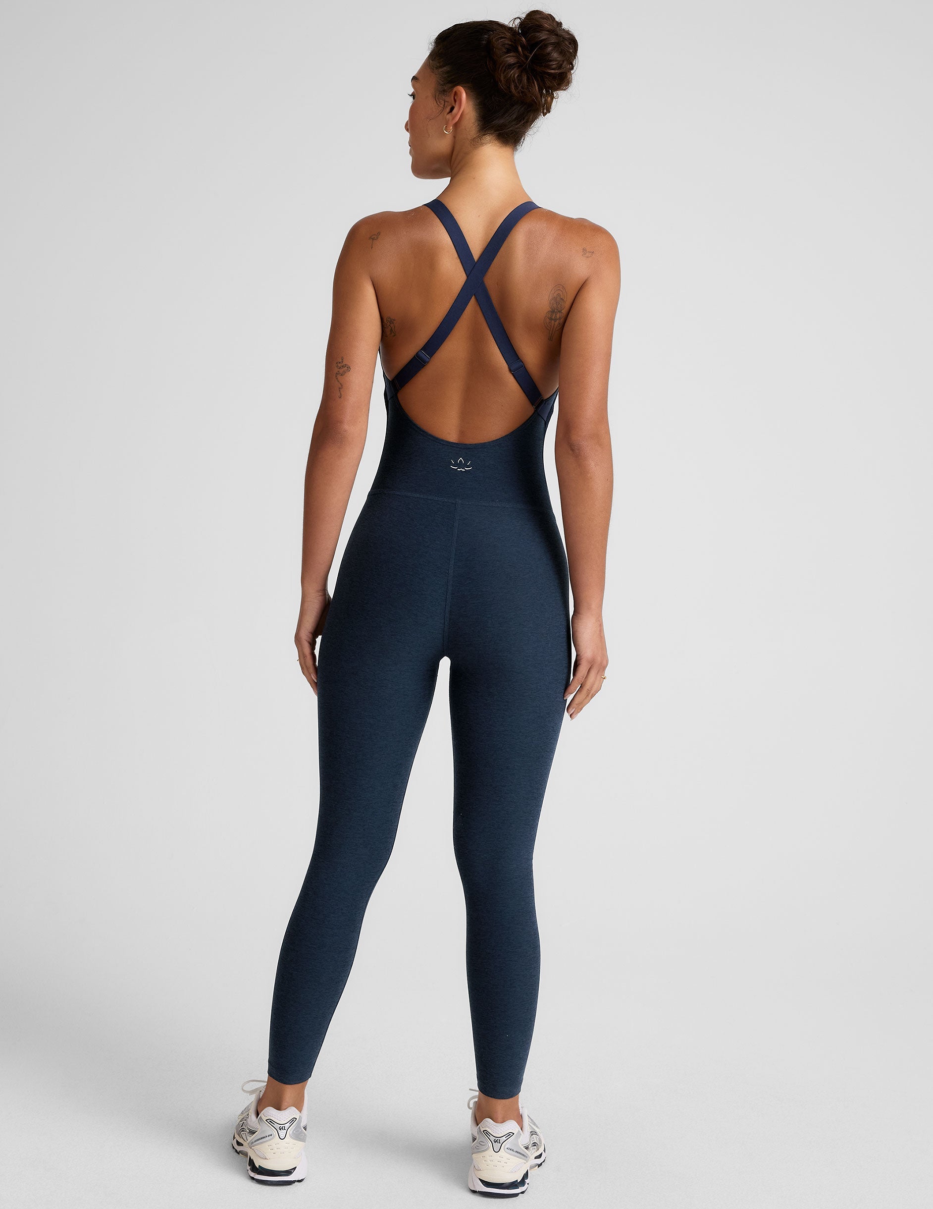 blue midi length jumpsuit with cross straps on back.