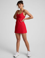 red mini dress with thin straps and built-in shorts with pockets.