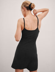 black mini dress with slim adjustable straps and built-in shorts with pockets.