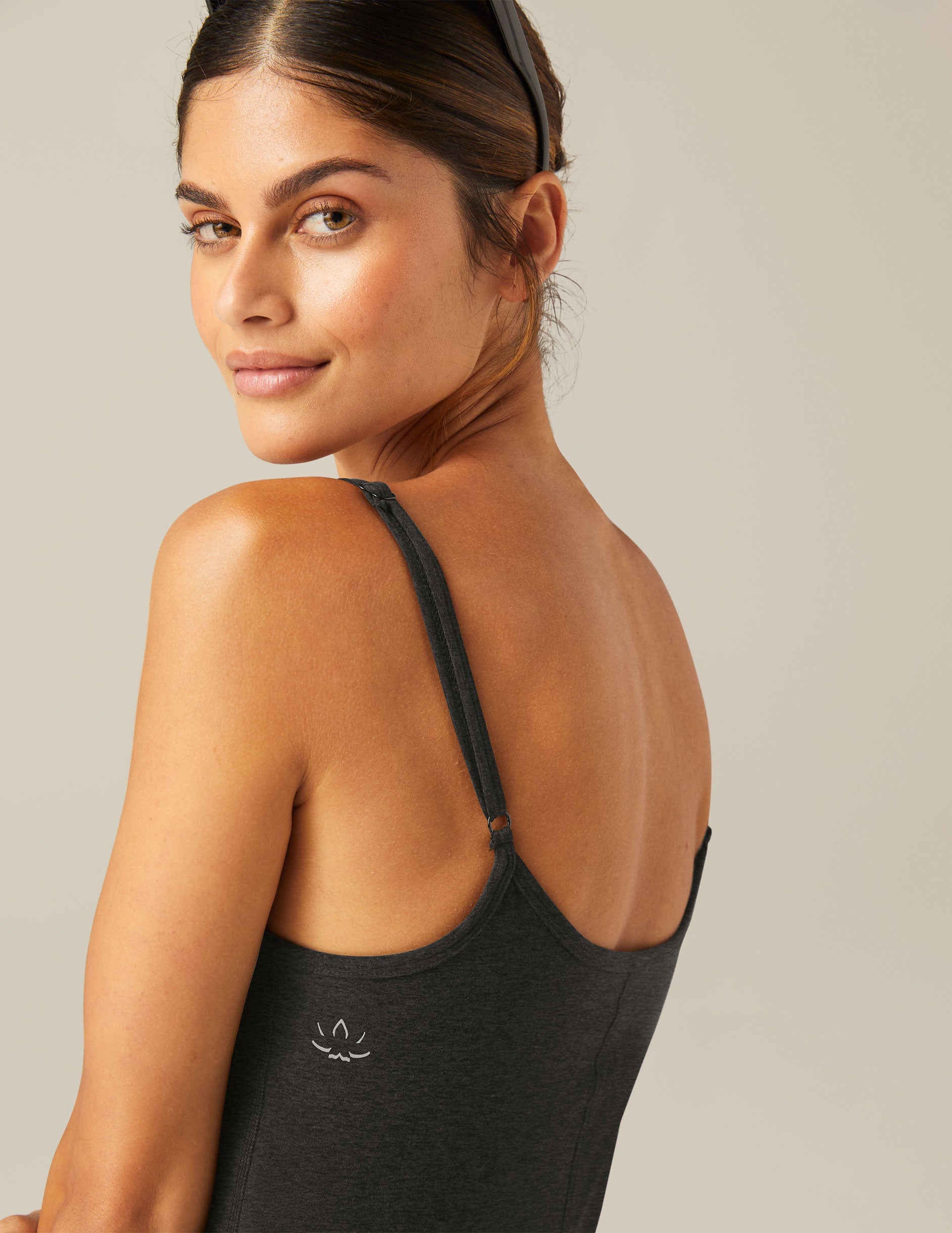 black mini dress with slim adjustable straps and built-in shorts with pockets.