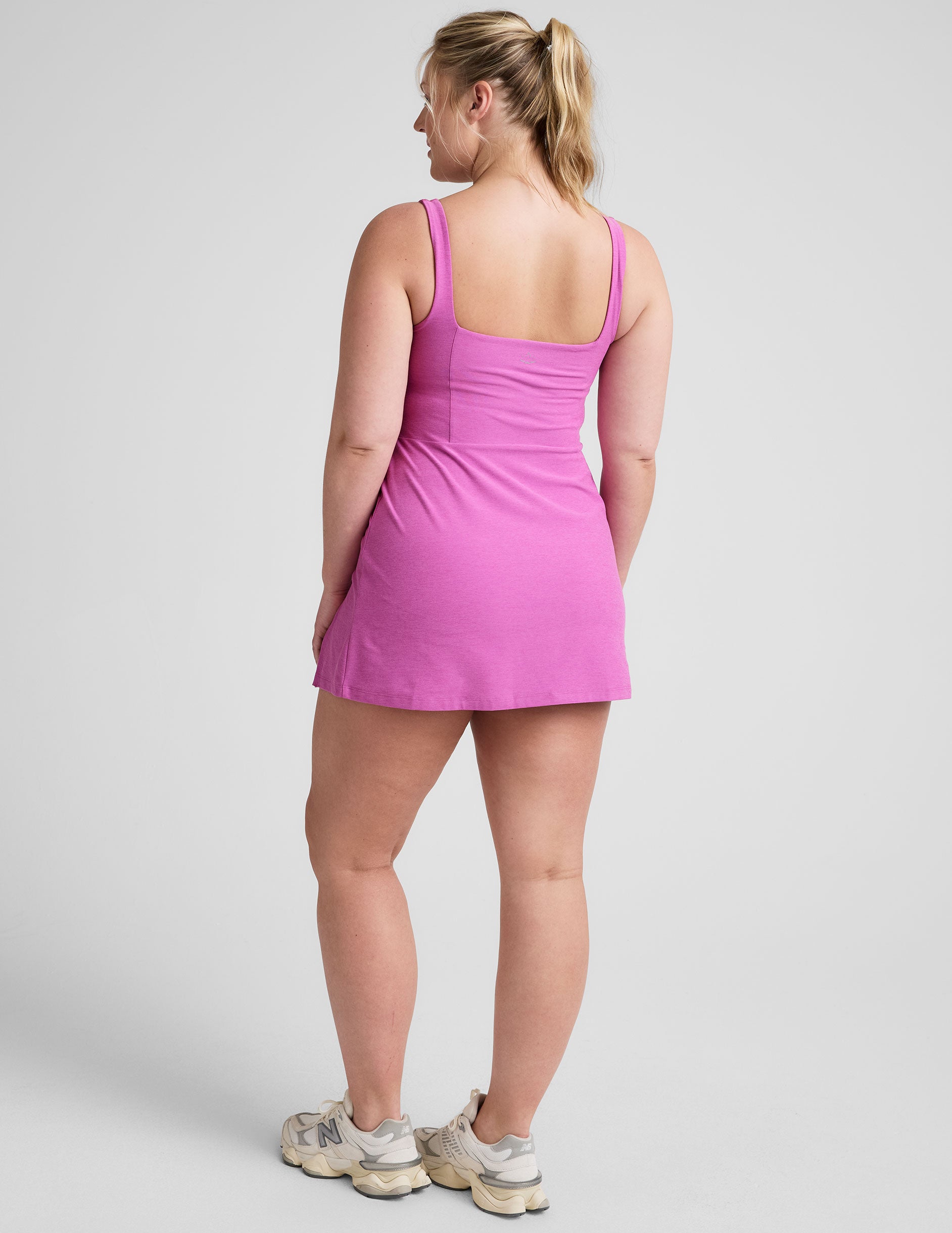 purple mini tank dress with a square neckline, side slit, and built-in shorts with pockets. 