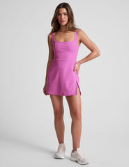 purple mini tank dress with a square neckline, side slit, and built-in shorts with pockets. 