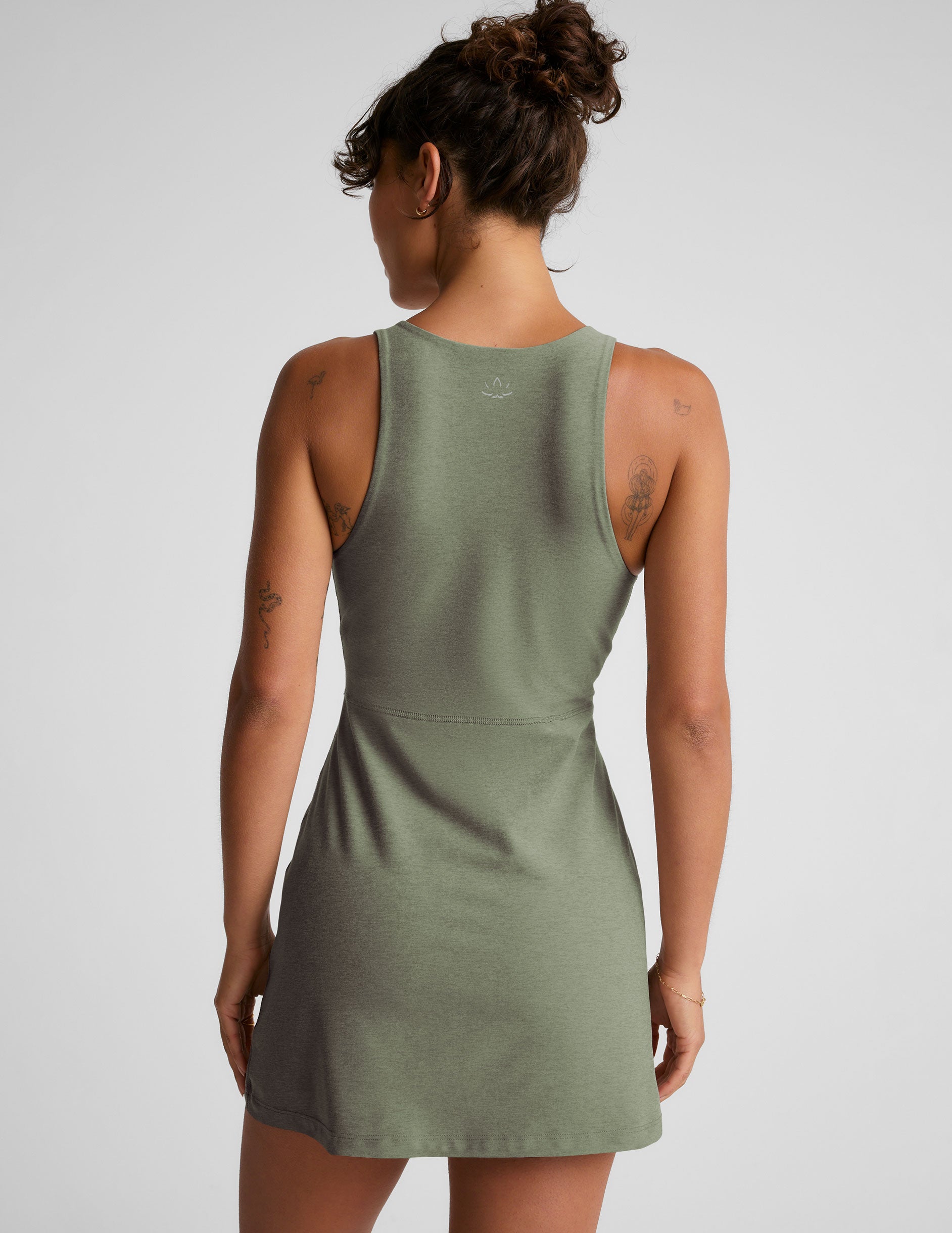 green mini active dress with a zipper on the front neckline and a side slit.
