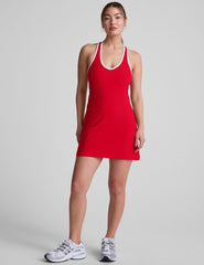red mini dress with white trim and a back crossover strap detail.