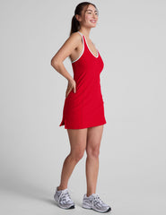 red mini dress with white trim and a back crossover strap detail.