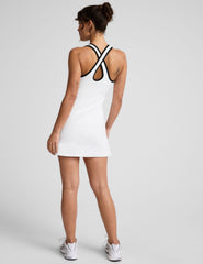white mini dress with black piping and shorts built-in.
