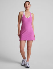 pink mini length dress with a front V neckline​, back keyhole detail, contrast binding at neckline and arm openings​, and interior bodysuit with pockets​. 