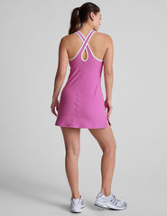 pink mini length dress with a front V neckline​, back keyhole detail, contrast binding at neckline and arm openings​, and interior bodysuit with pockets​. 