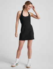black mini style dress with an over the neck halter strap and a built-in bodysuit with pockets.