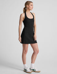 black mini style dress with an over the neck halter strap and a built-in bodysuit with pockets.