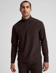 model wearing a brown men's quarter-zip pullover against a plain background.