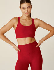 red scoop neck bra top with a twist strap detail in back.