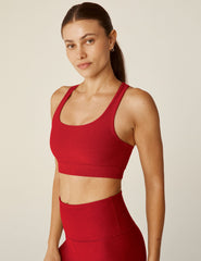 red scoop neck bra top with a twist strap detail in back.