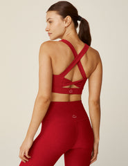 red scoop neck bra top with a twist strap detail in back.
